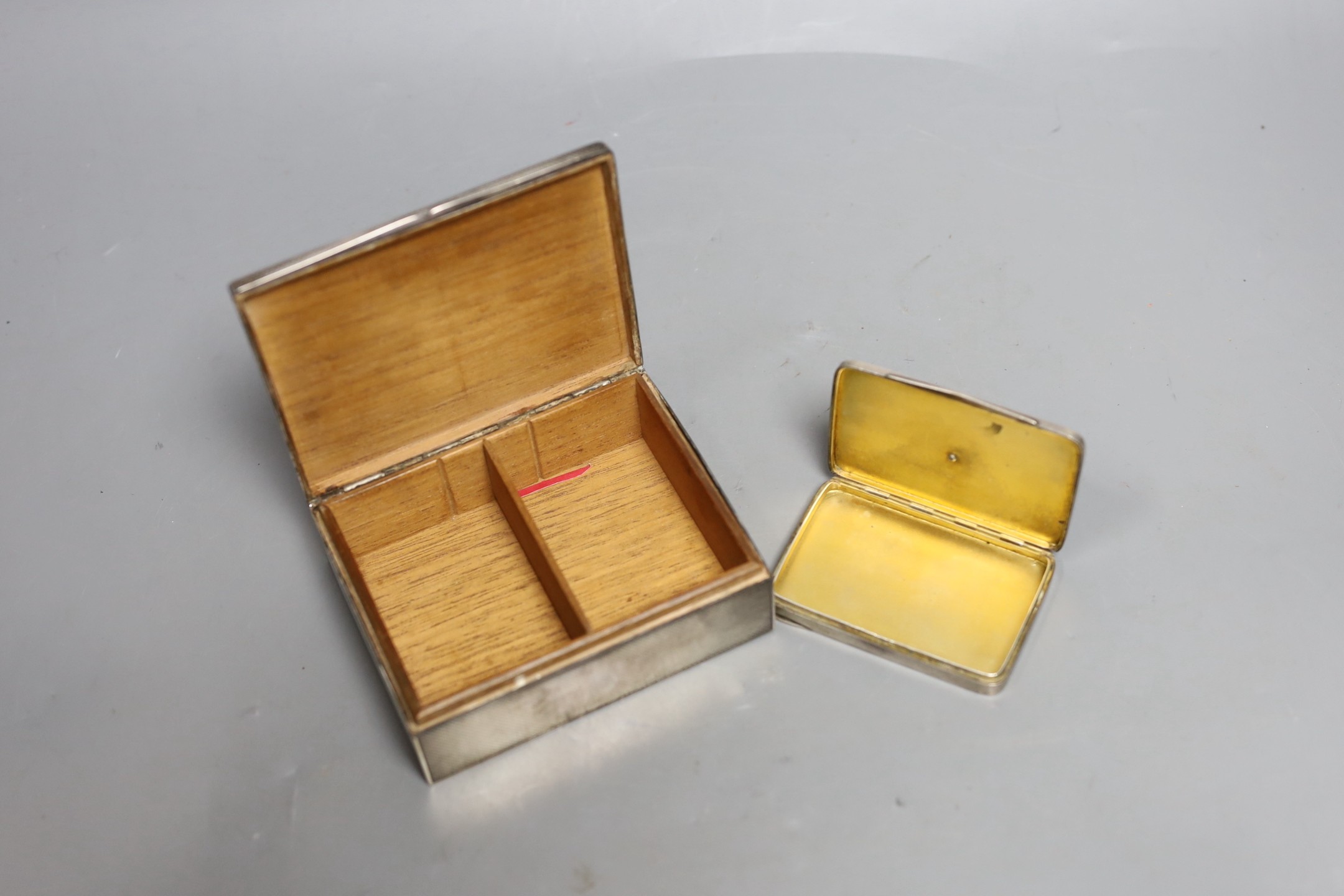 A George V silver and blue enamel cigarette box, import marks for London, 1928, 11.3cm and a Swedish white metal and enamel compact.